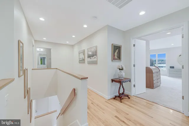 a living room with furniture a flat screen tv and a large window