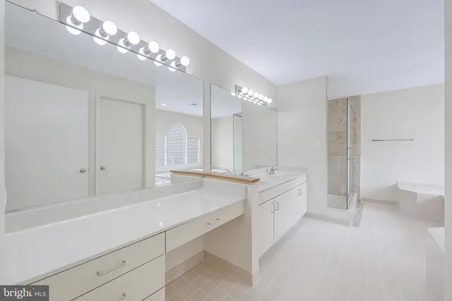 a bathroom with a sink double vanity granite and a mirror