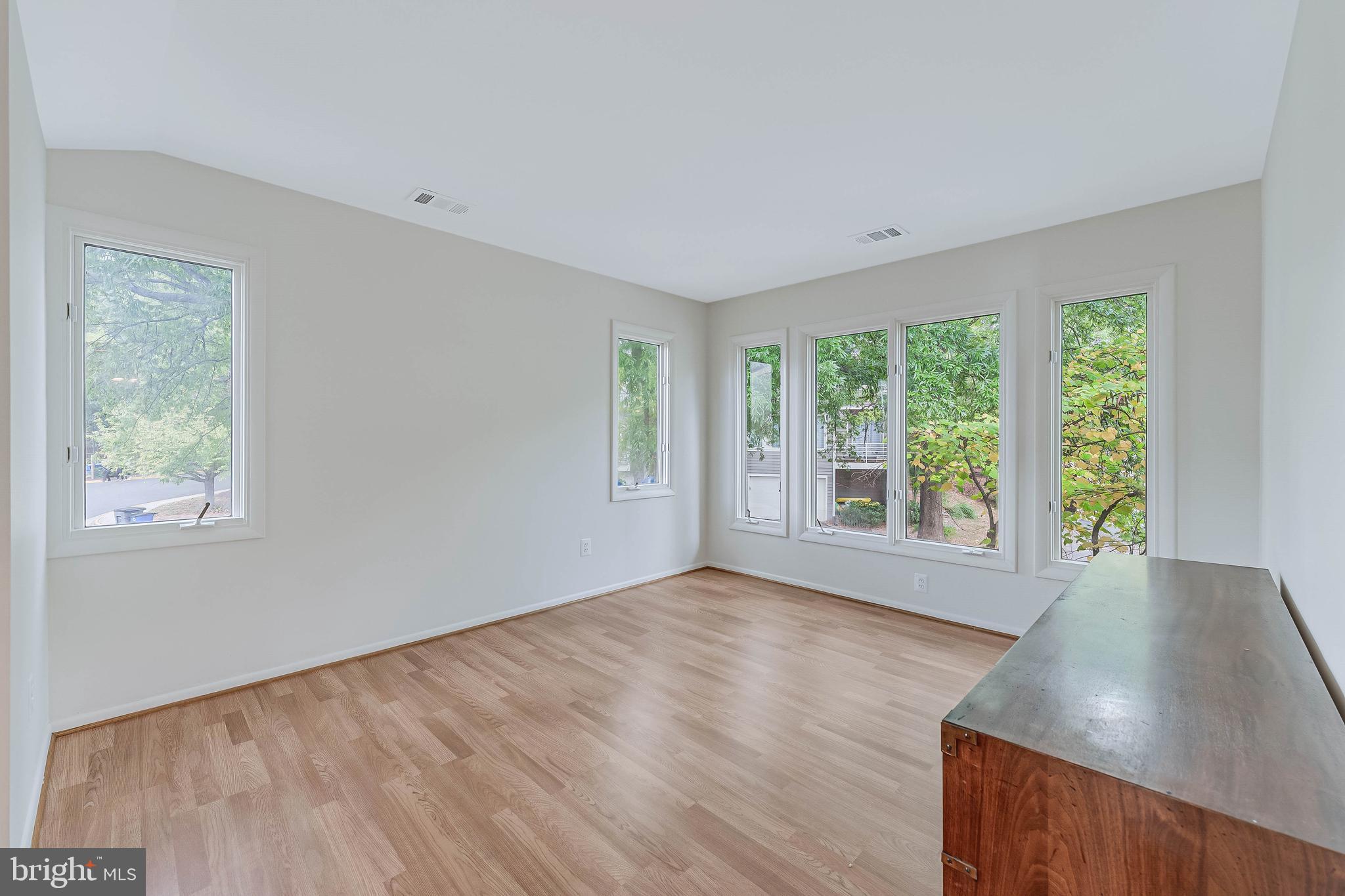 1933 Lakeport Way Reston, VA 20191 - Photo 44 of 57 a view of an empty room with wooden floor and a window