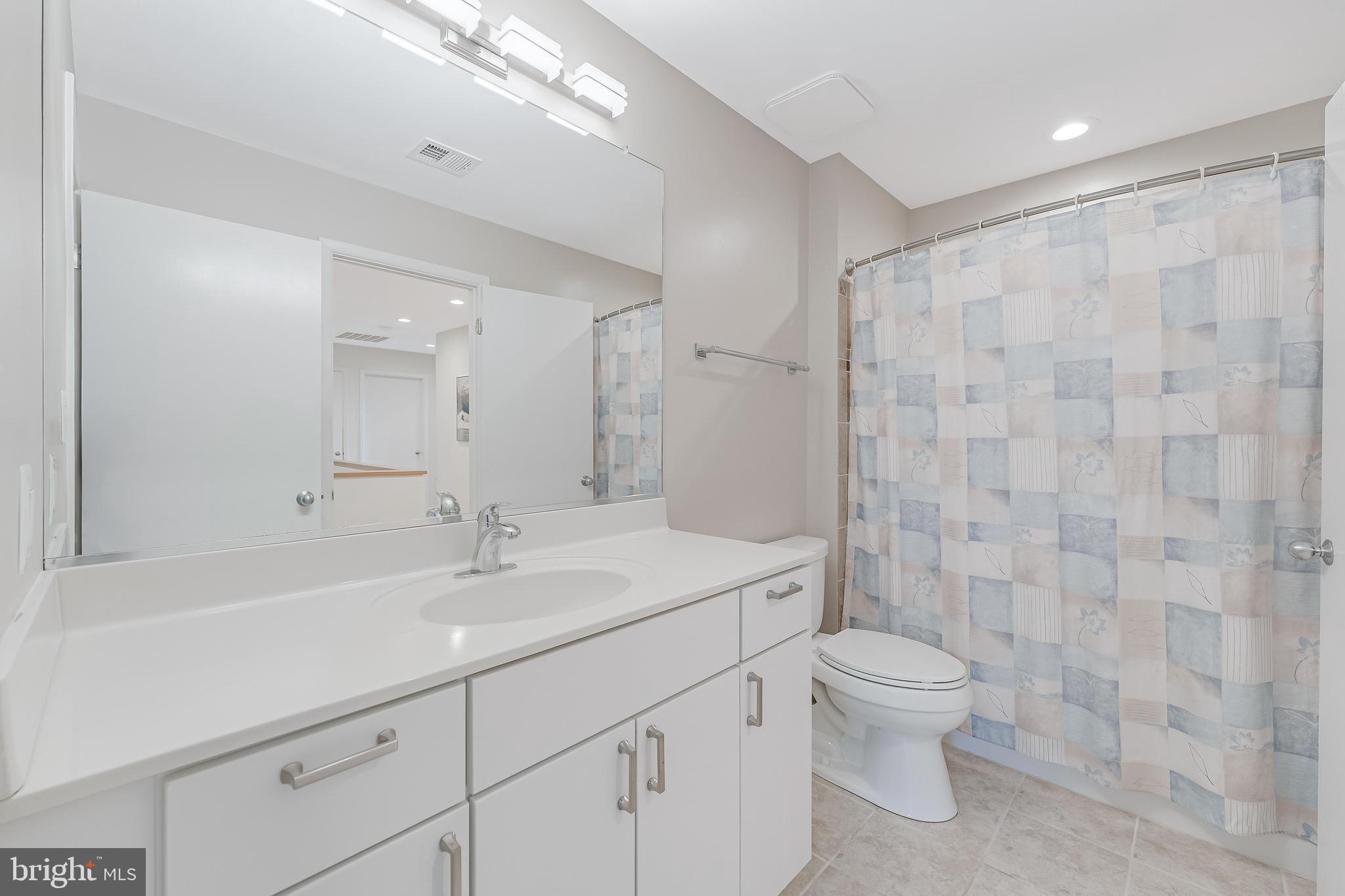 1933 Lakeport Way Reston, VA 20191 - Photo 47 of 57 a bathroom with a sink a toilet and shower