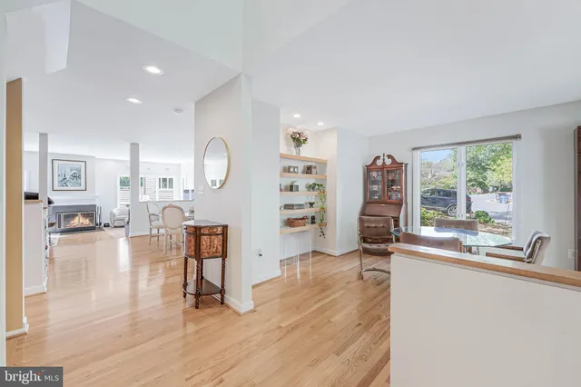 a living room with furniture a fireplace and a large window