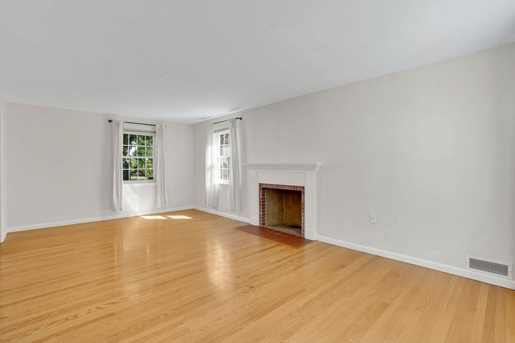 138 Abbott Street Springfield, MA 01118 - Photo 14 of 41 a view of empty room with wooden floor and fireplace