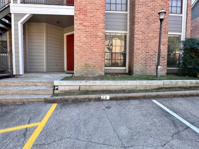 a view of a brick house with a yard