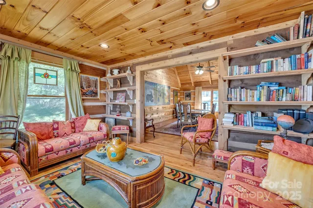 a living room with lots of furniture and a book shelf
