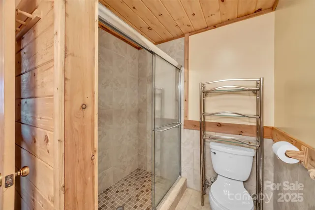 a bathroom with a toilet and a shower