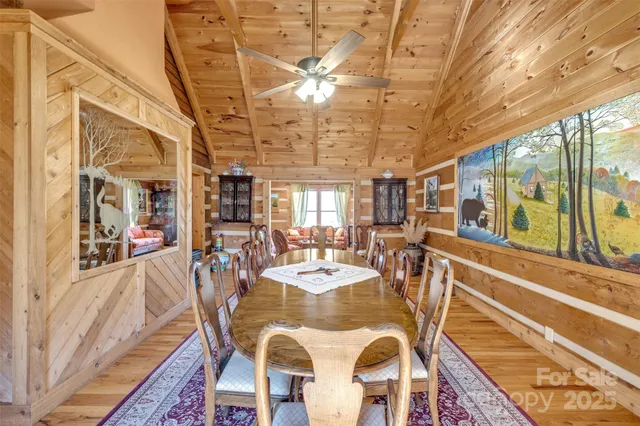 a view of a dining room with furniture a chandelier and wooden floor