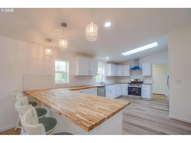 a kitchen with cabinets and stainless steel appliances