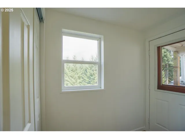 a view of an empty room and wooden floor