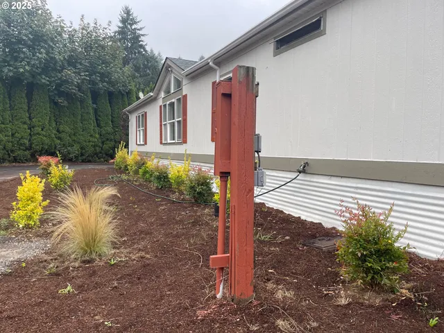 a backyard of a house with fountain table and chairs