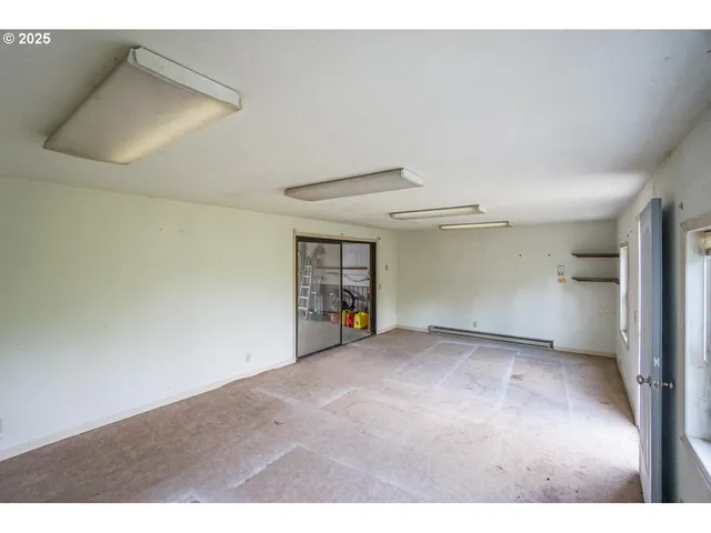 a view of empty room with wooden floor and cabinet