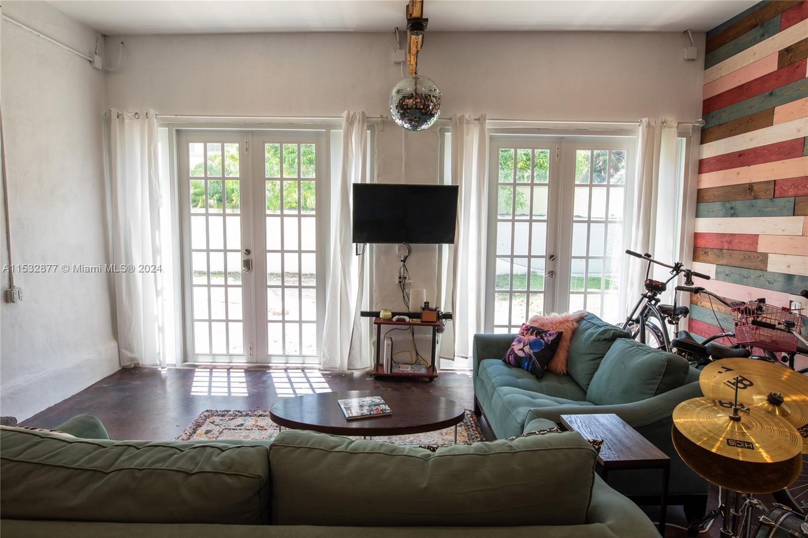 2112 Alton Road Miami Beach, FL 33140 - Photo 14 of 15 a living room with furniture and a flat screen tv