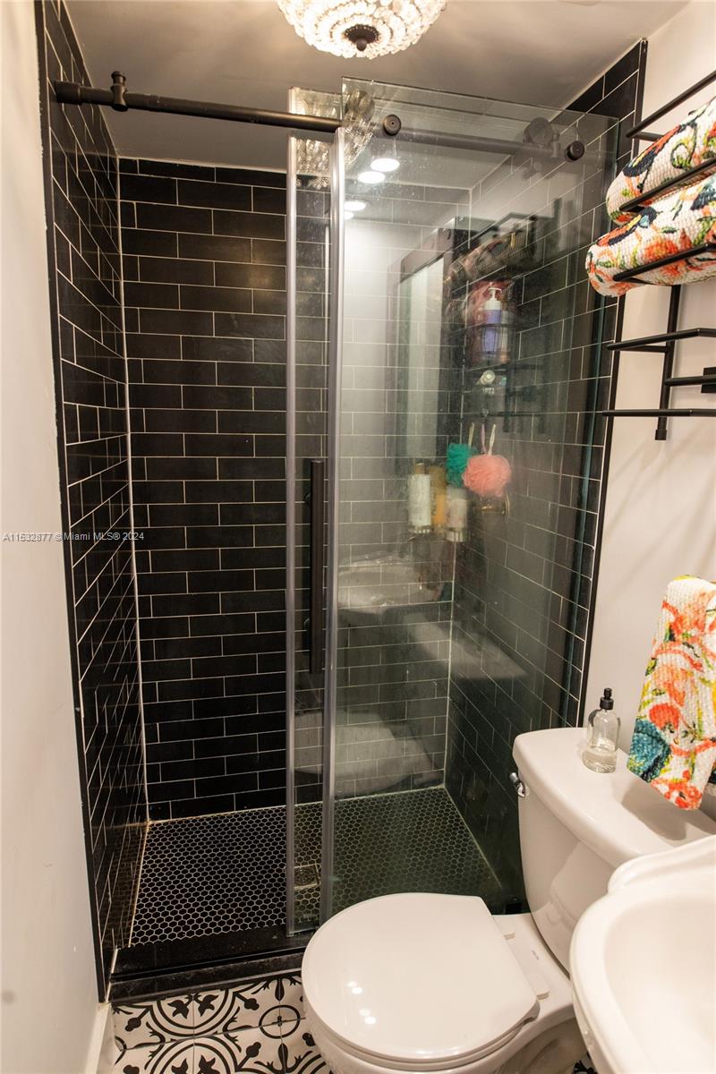 2112 Alton Road Miami Beach, FL 33140 - Photo 15 of 15 a bathroom with a toilet and a shower