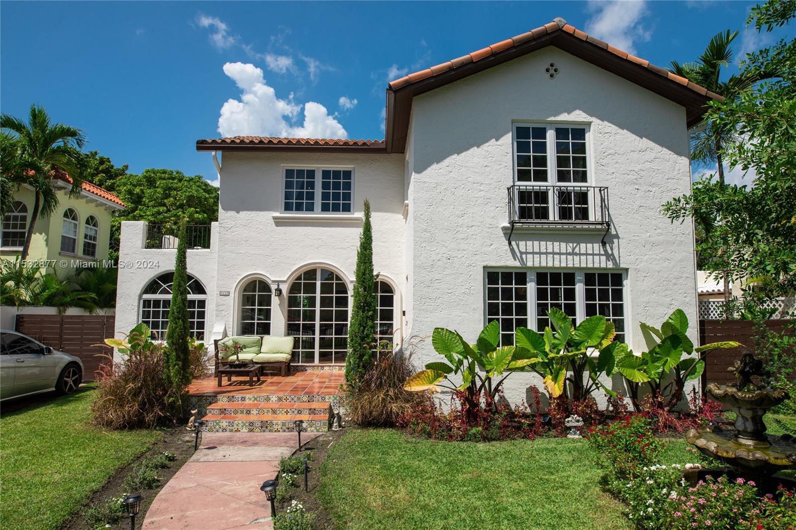 2112 Alton Road Miami Beach, FL 33140 - Photo 2 of 15 a front view of a house with a yard