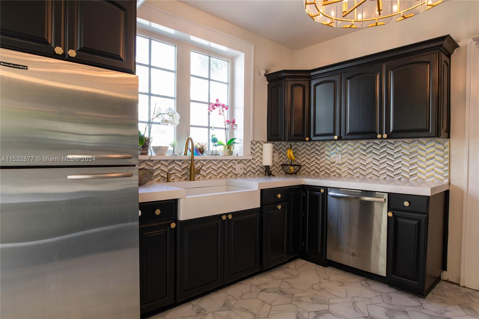 2112 Alton Road Miami Beach, FL 33140 - Photo 10 of 15 a kitchen with a sink stove and cabinets