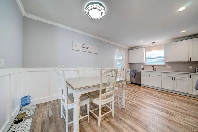 a kitchen with furniture cabinets and stainless steel appliances