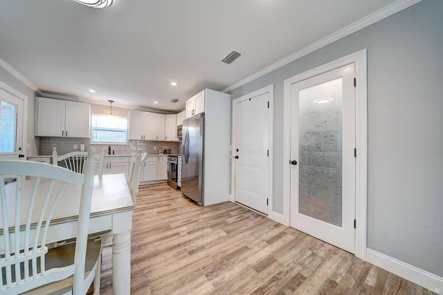 a view of kitchen with stainless steel appliances refrigerator oven and cabinets