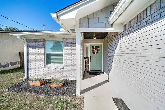 a front view of a house with outdoor seating