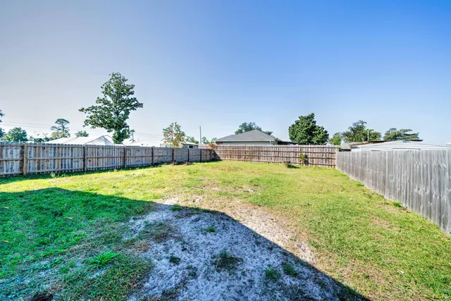 a view of yard with swimming pool and seating area
