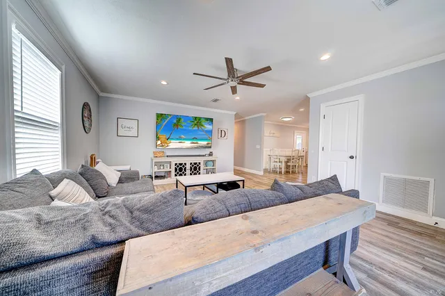 a living room with furniture a large window and a flat screen tv