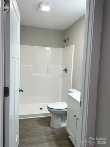 a bathroom with a toilet and a shower