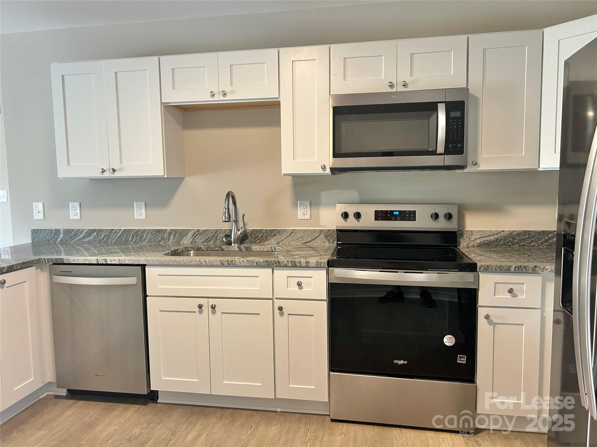 3291 Paul Elmore Road Lincolnton, NC 28092 - Photo 14 of 17 a kitchen with stainless steel appliances granite countertop a stove a sink and a microwave