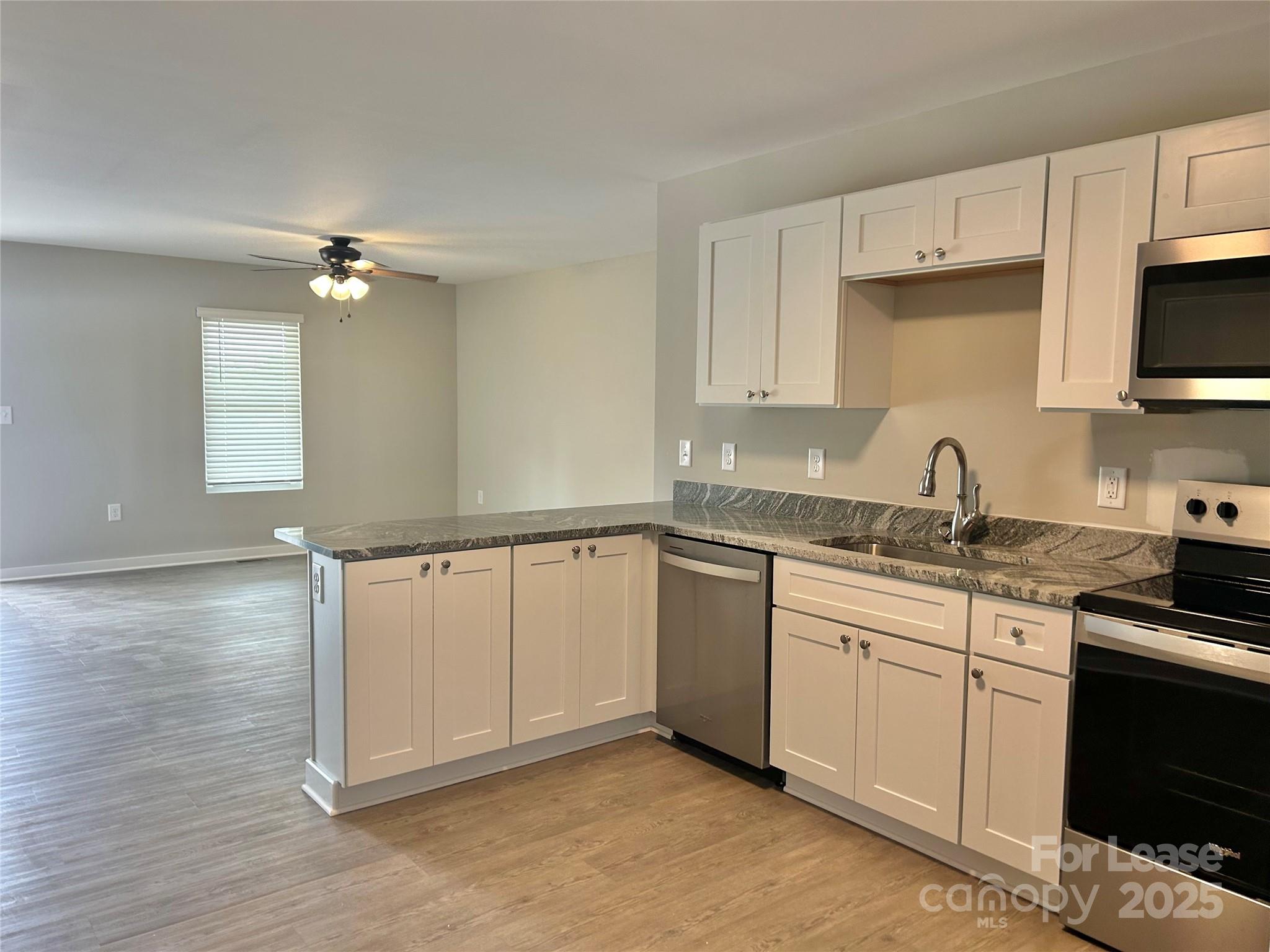 3291 Paul Elmore Road Lincolnton, NC 28092 - Photo 15 of 17 a kitchen with granite countertop a sink stainless steel appliances and cabinets