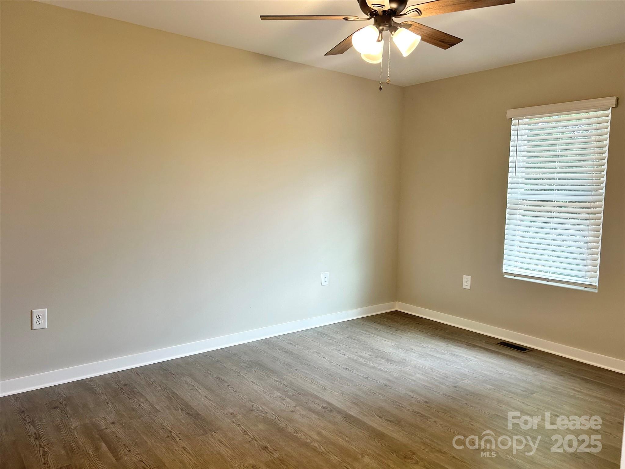 3291 Paul Elmore Road Lincolnton, NC 28092 - Photo 10 of 17 an empty room with a window and a ceiling fan