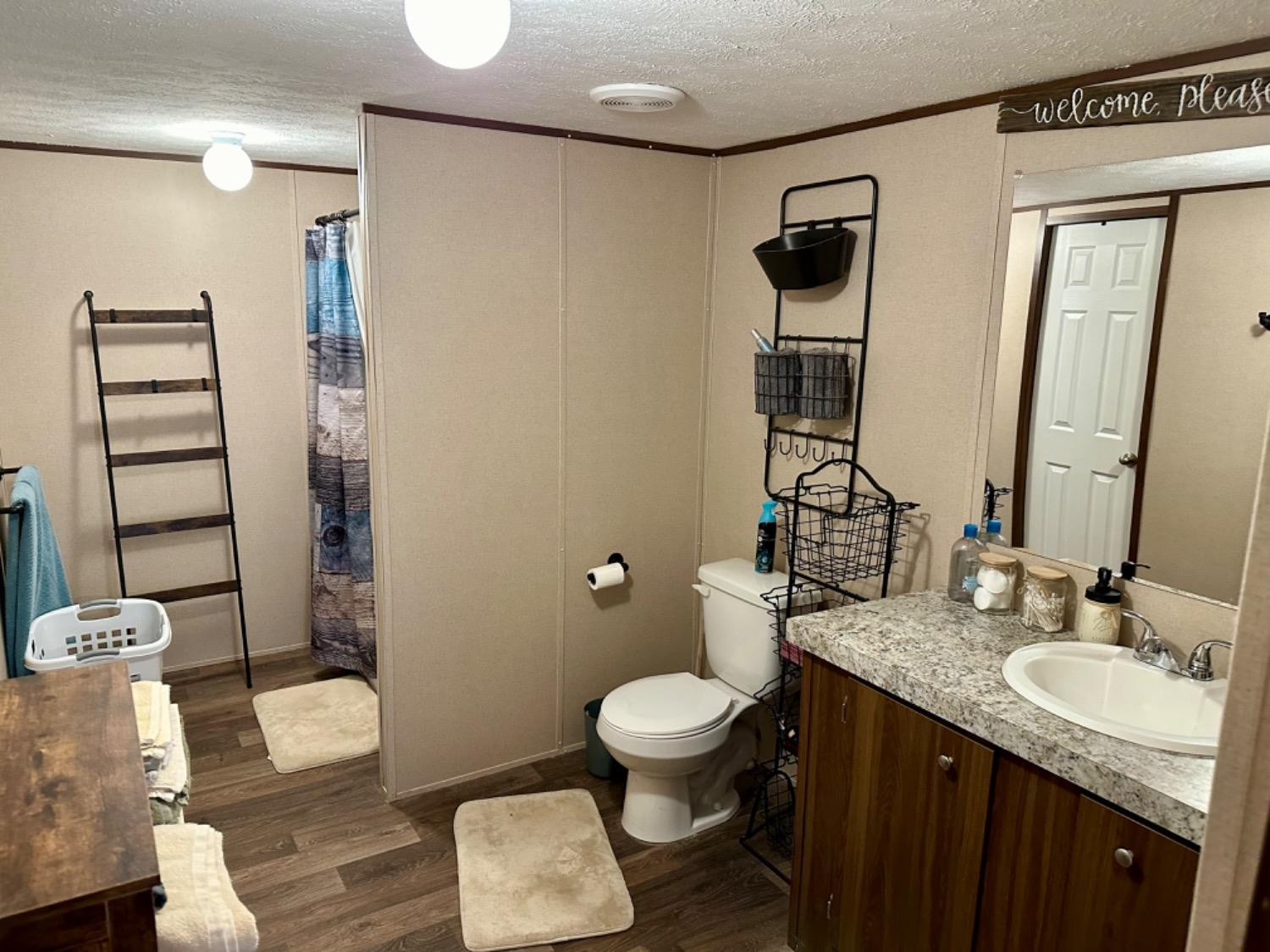 760 Highway 82 Ralls, TX 79357 - Photo 20 of 25 a bathroom with a granite countertop sink toilet and shower