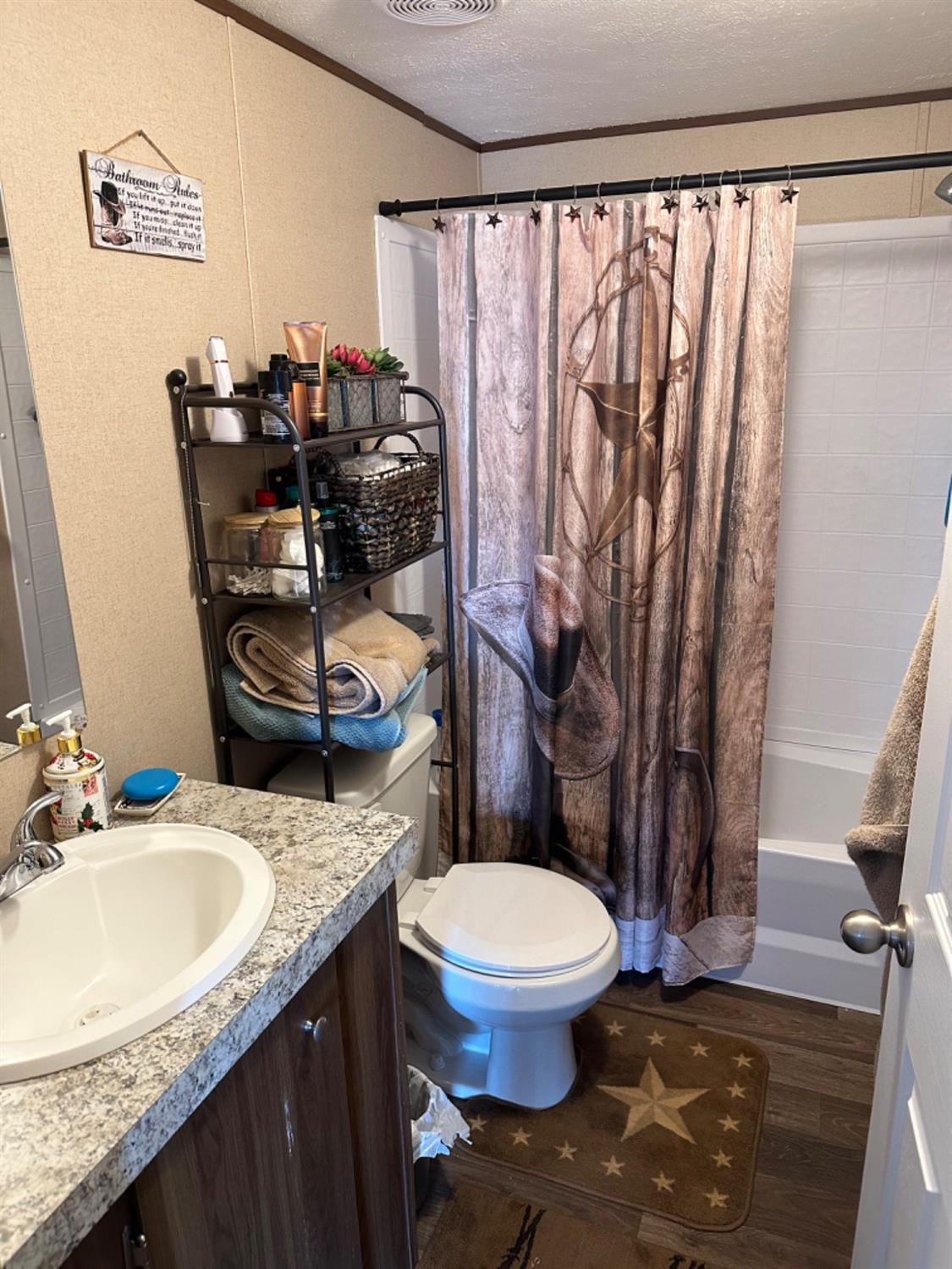 760 Highway 82 Ralls, TX 79357 - Photo 24 of 25 a bathroom with a granite countertop sink toilet and a mirror