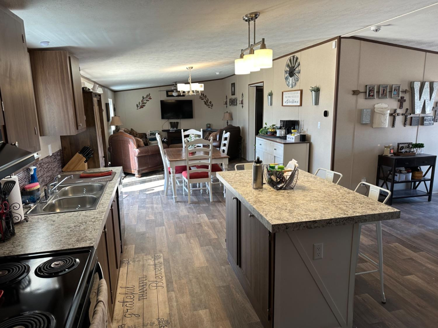 760 Highway 82 Ralls, TX 79357 - Photo 9 of 25 a kitchen with stainless steel appliances granite countertop a sink dishwasher stove refrigerator and cabinets