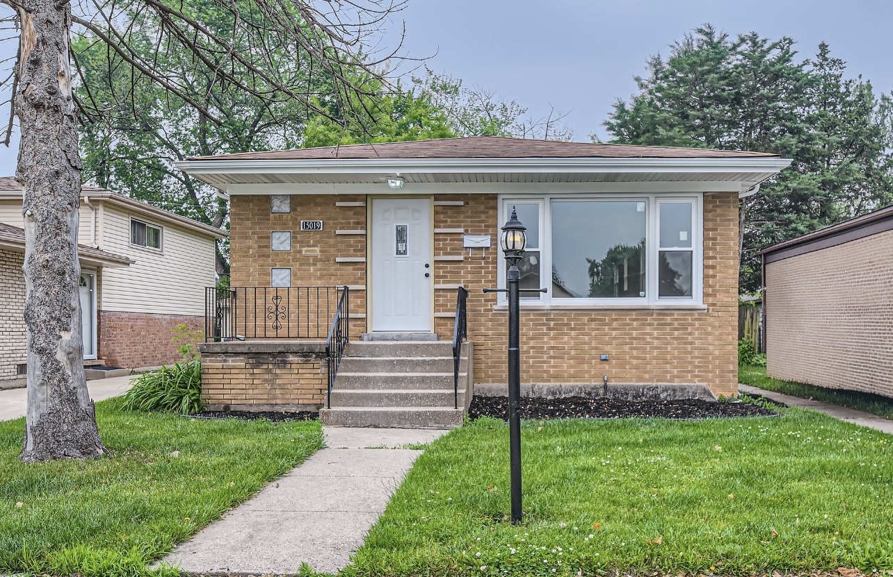 15019 Evers Street Dolton, IL 60419 - Photo 1 of 8 a front view of a house with a garden