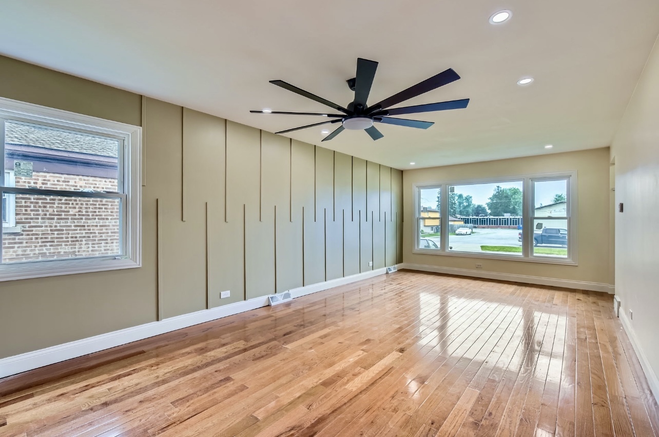 15019 Evers Street Dolton, IL 60419 - Photo 3 of 8 a view of n empty room with wooden floor and a window