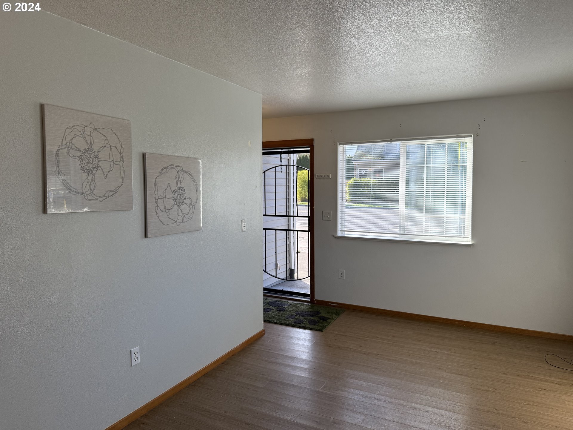 9845 North Lombard Street Portland, OR 97203 - Photo 11 of 35 an empty room with wooden floor and windows