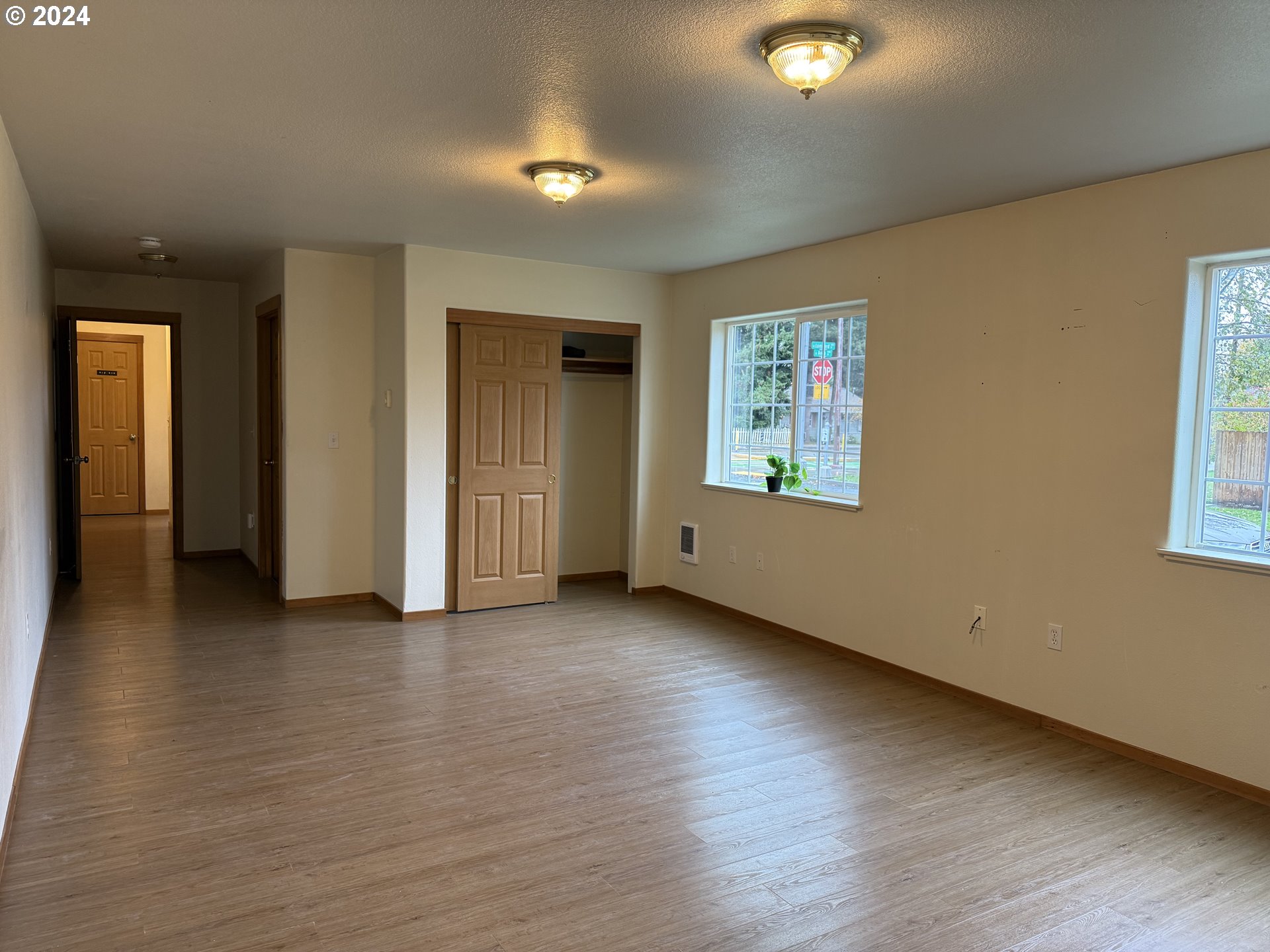 9845 North Lombard Street Portland, OR 97203 - Photo 14 of 35 an empty room with wooden floor and windows