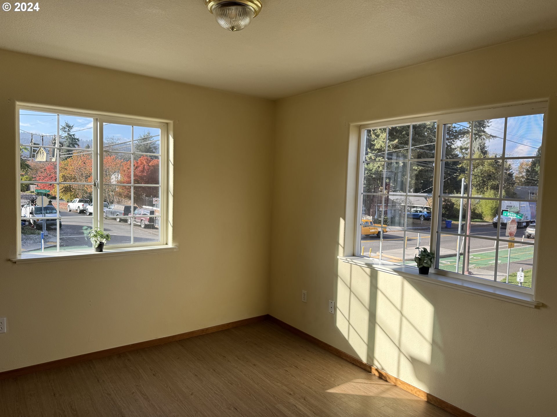 9845 North Lombard Street Portland, OR 97203 - Photo 19 of 35 an empty room with wooden floor and windows