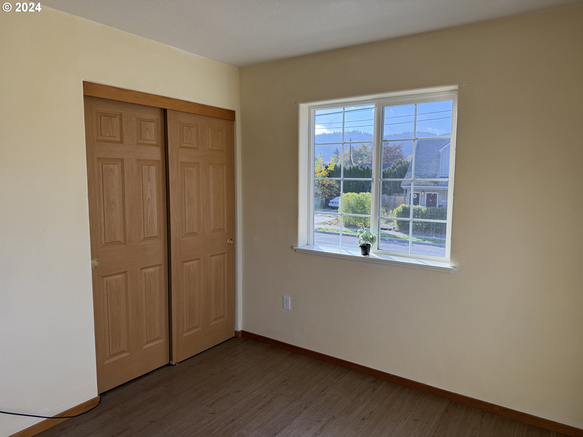 9845 North Lombard Street Portland, OR 97203 - Photo 22 of 35 an empty room with wooden floor and windows