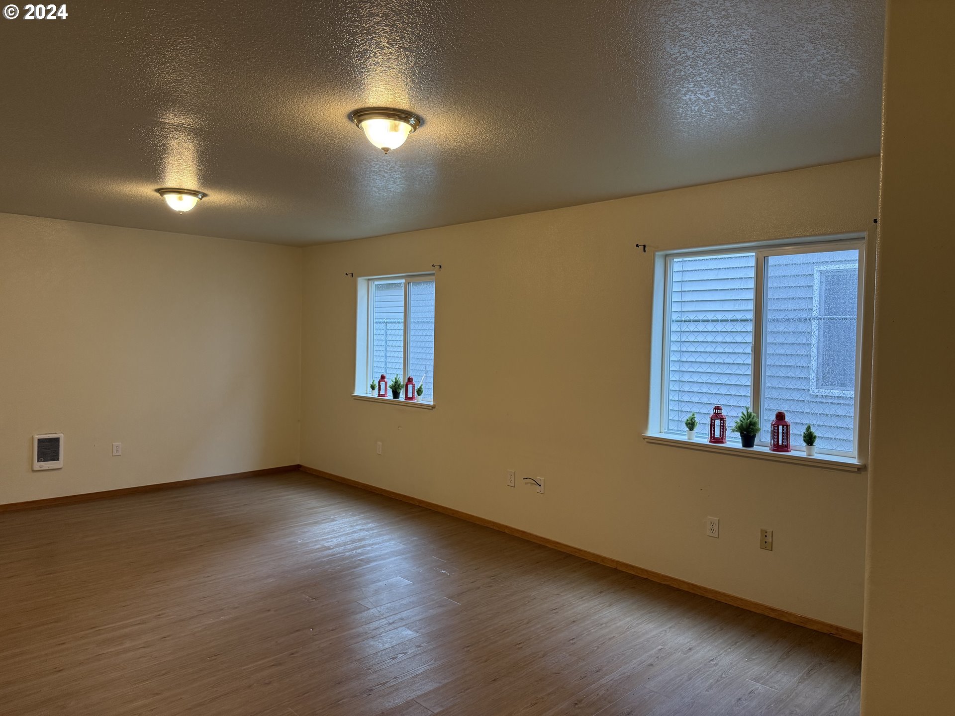 9845 North Lombard Street Portland, OR 97203 - Photo 23 of 35 an empty room with wooden floor and windows