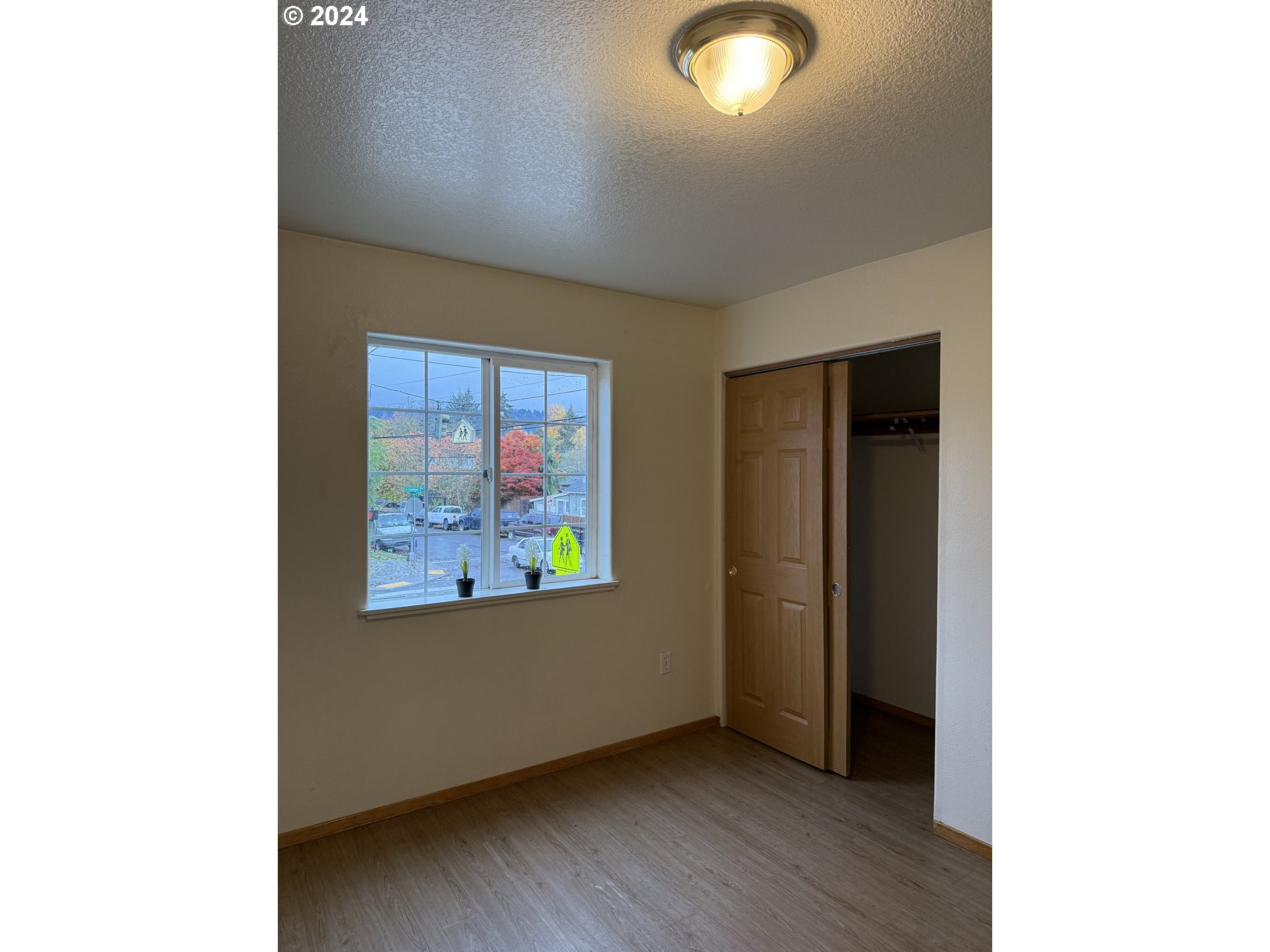 9845 North Lombard Street Portland, OR 97203 - Photo 29 of 35 a view of an empty room with wooden floor and a window