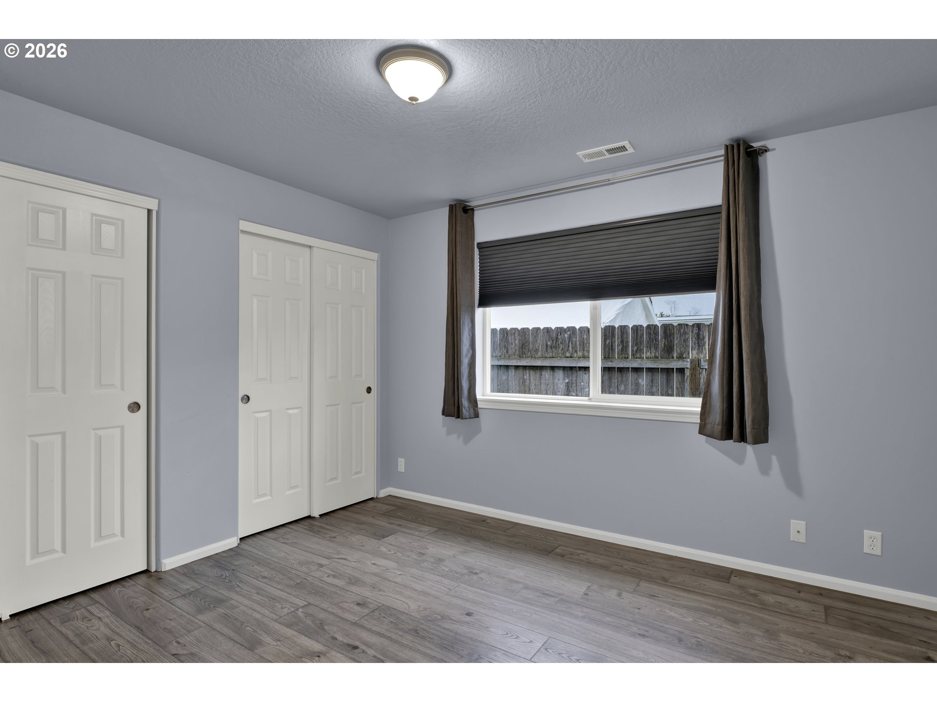 340 54th Street Springfield, OR 97478 - Photo 22 of 33 a view of an empty room with wooden floor and a window