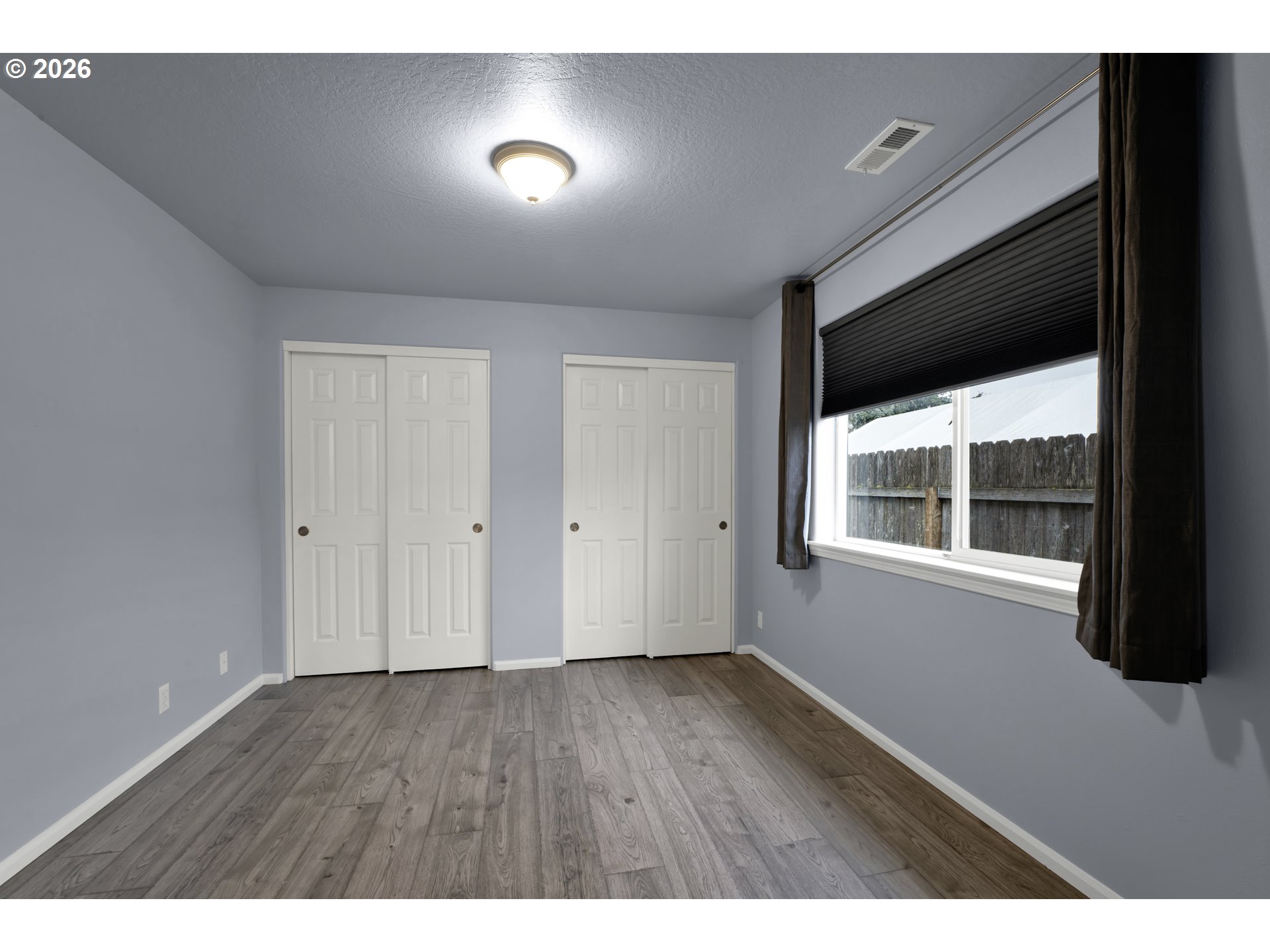 340 54th Street Springfield, OR 97478 - Photo 23 of 33 a view of an empty room with wooden floor and windows