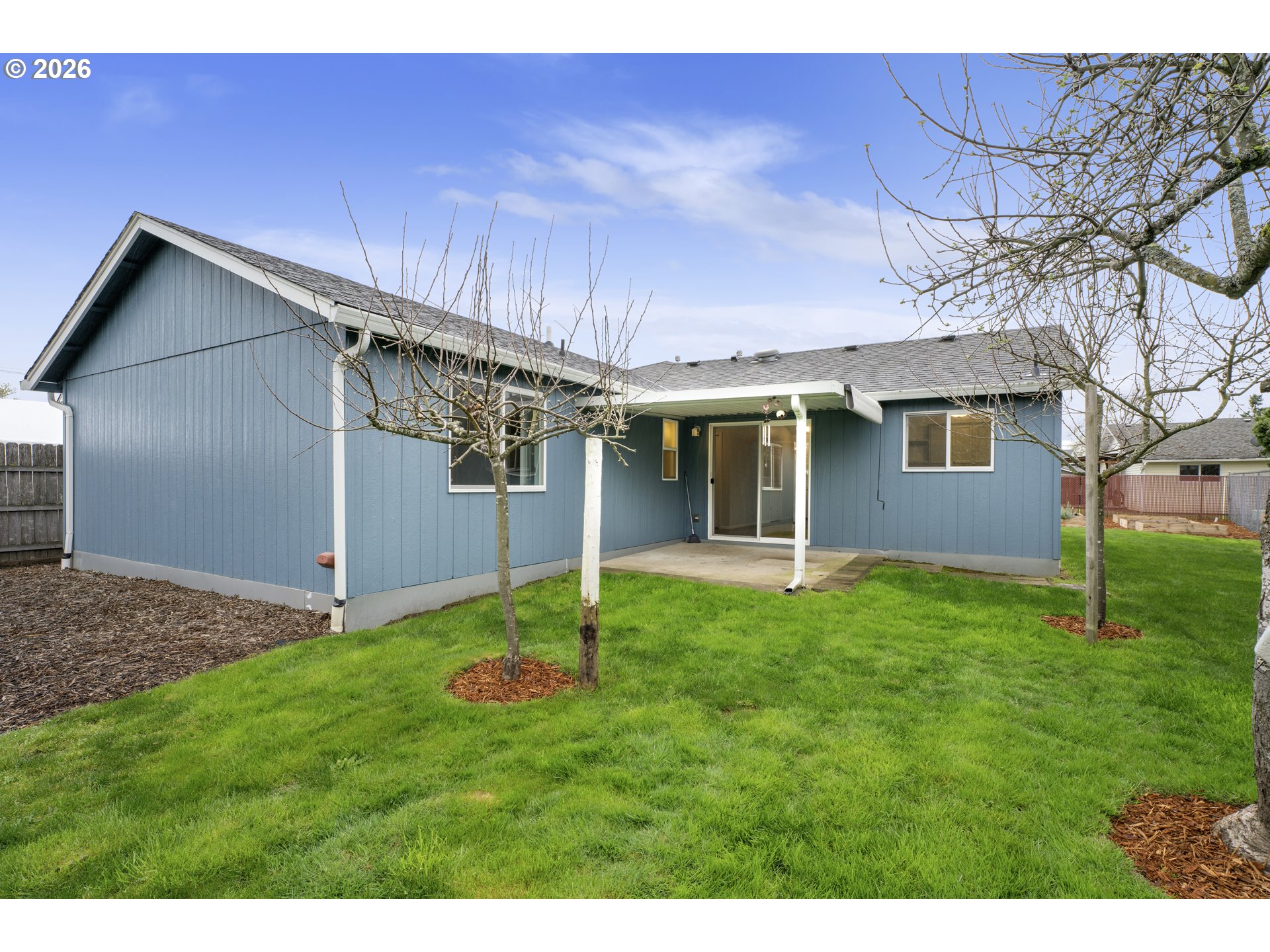 340 54th Street Springfield, OR 97478 - Photo 28 of 33 a backyard of a house with plants and large tree