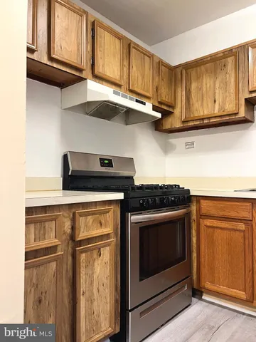 a kitchen with stainless steel appliances granite countertop cabinets and a stove top oven