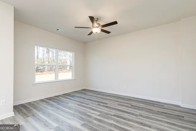 wooden floor in an empty room with a window