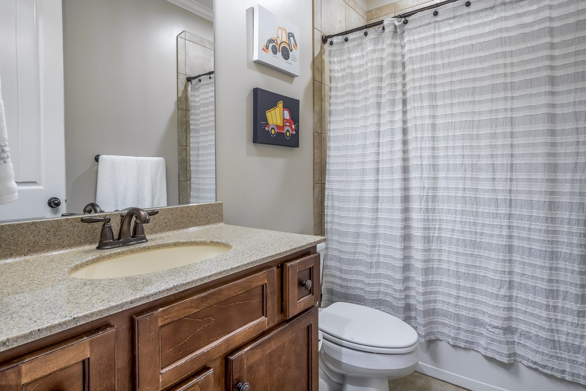 1347 Conser Street Collierville, TN 38017 - Photo 13 of 25 a bathroom with a granite countertop toilet sink and mirror