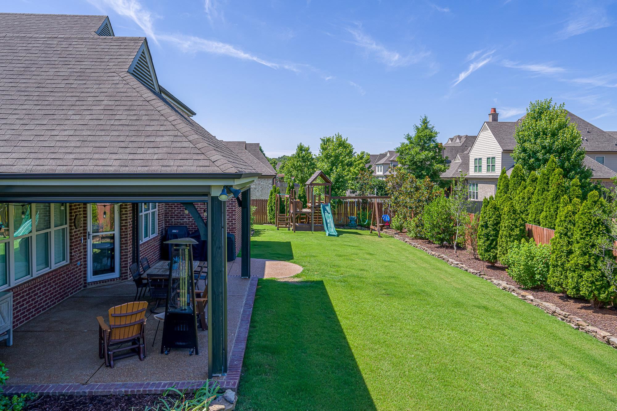 1347 Conser Street Collierville, TN 38017 - Photo 22 of 25 a view of a patio with table and chairs potted plants and floor to ceiling window
