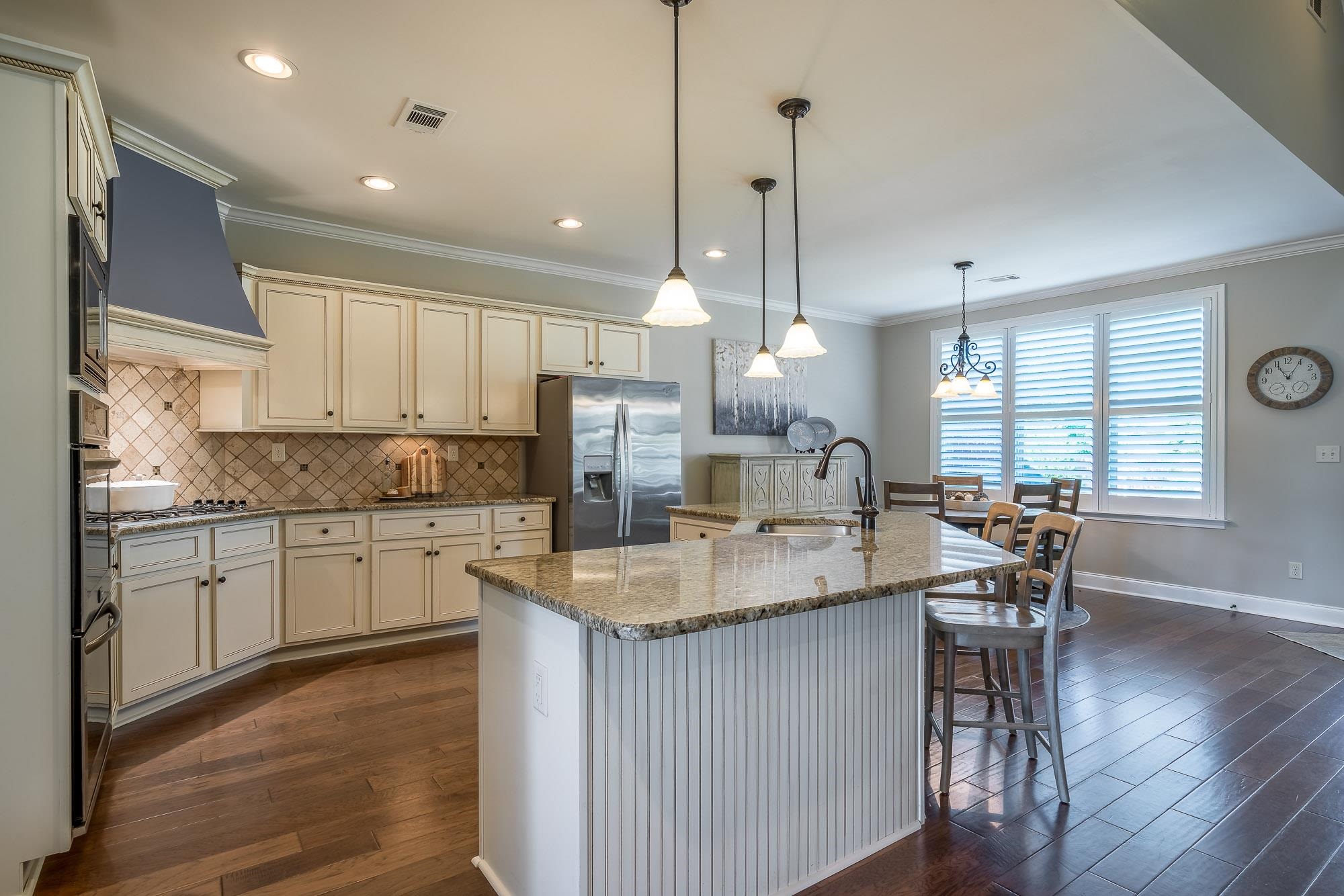 1347 Conser Street Collierville, TN 38017 - Photo 5 of 25 a kitchen with stainless steel appliances granite countertop sink stove refrigerator and wooden floor