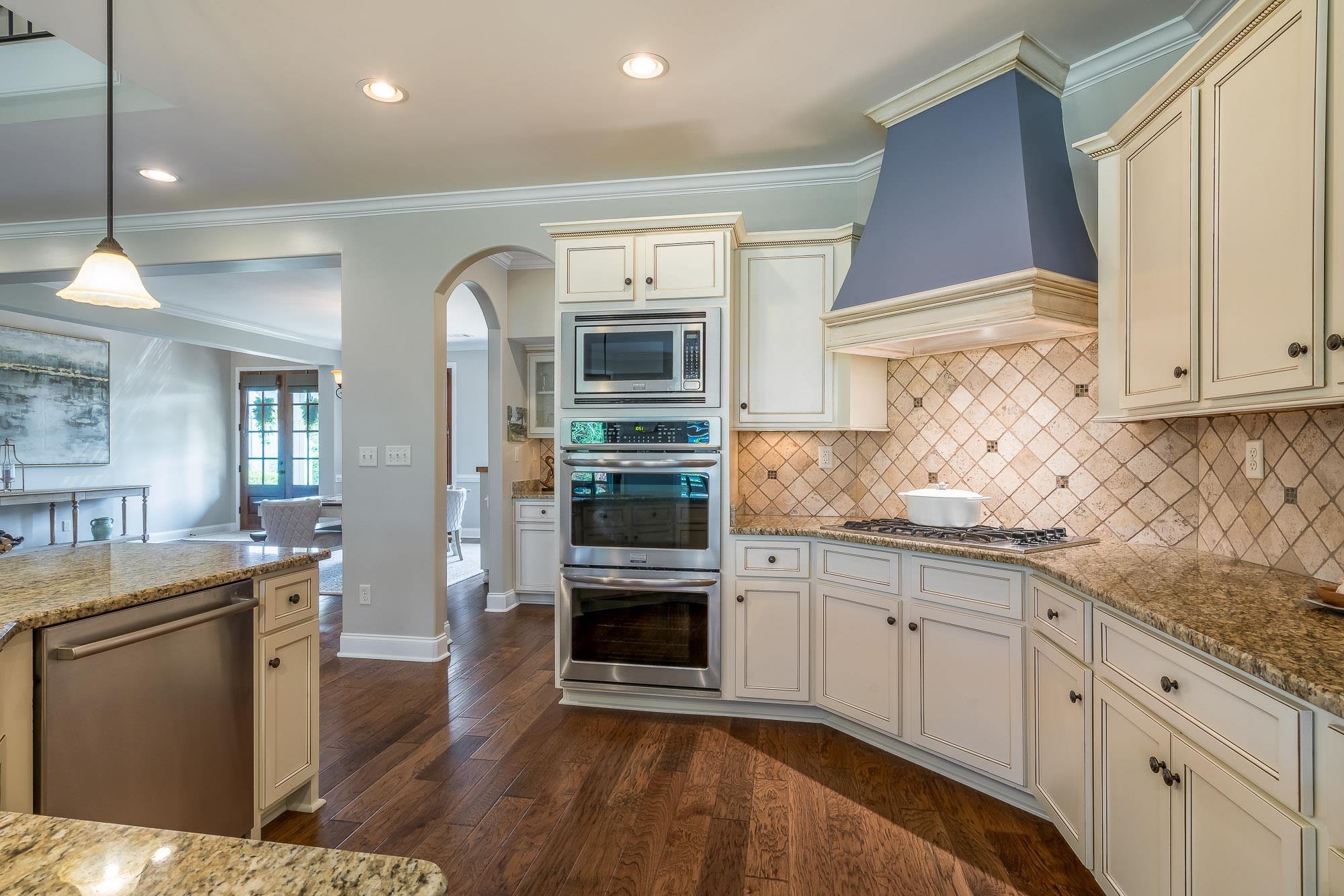 1347 Conser Street Collierville, TN 38017 - Photo 7 of 25 a kitchen with granite countertop a sink stainless steel appliances and cabinets