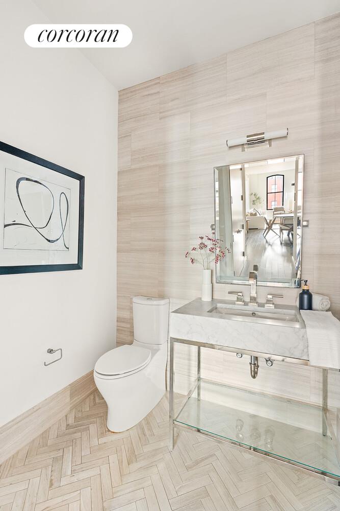250 West Street, Unit 8H Manhattan, NY 10013 - Photo 15 of 16 a bathroom with a sink mirror vanity and toilet