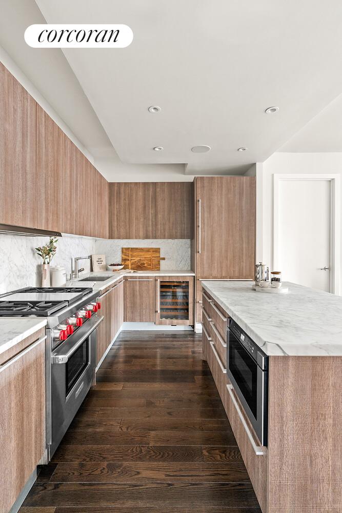 250 West Street, Unit 8H Manhattan, NY 10013 - Photo 4 of 16 a kitchen with stainless steel appliances granite countertop a stove top oven a sink and dishwasher