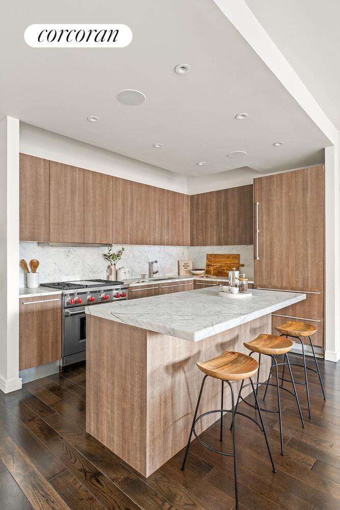 250 West Street, Unit 8H Manhattan, NY 10013 - Photo 5 of 16 a kitchen with stainless steel appliances granite countertop a table chairs sink and cabinets